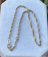 Full view of rope anklet laid flat on display pad