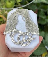 Bracelet on display block showing multi-strand chains and rhinestone toggle