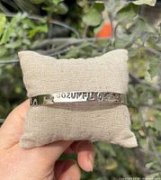 Front view showing COZUMEL cut-out and floral motifs on bangle