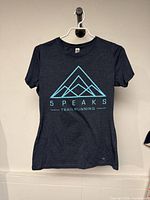 Front view of heather navy t-shirt with turquoise 5 Peaks Trail Running logo