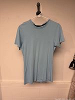 Front view of light blue Calvin Klein t-shirt on hanger