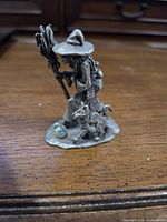 Front view of pewter witch figurine with cat and marble accent