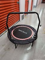 Full view of KANCHIMI mini trampoline with handlebar in storage corridor