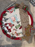 Overview of tree skirt, ornaments, carriage, ribbon, vase, cookbook