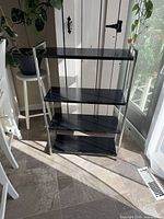 Full view of four-shelf black and chrome bookcase