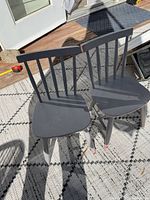 Pair of gray distressed wooden children's chairs on outdoor rug