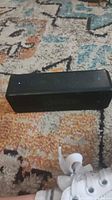 Front and top view showing Anker SoundCore Bluetooth speaker, buttons, LEDs and grille