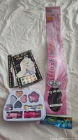 Entire lot displayed: makeup palette, Flash Braid accessory, two sticker booklets, candy pack
