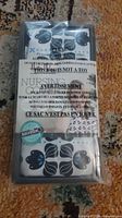 Front view of sealed package showing floral patterned nursing cover and warning label