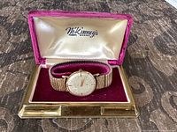 Watch in open N. Kinneys box showing dial and band