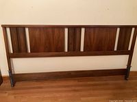 Front view of mid-century wooden king headboard