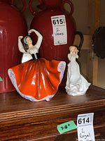 Both figurines on shelf showing relative size and lot tags