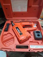 Framing nailer in molded case with battery and charger base