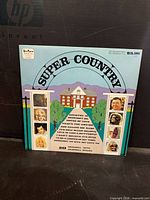 Front cover of Super Country LP showing title, artwork and artists photos