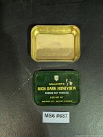 Tin with lid removed showing interior and lid exterior