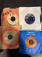 All four singles front view showing labels and sleeves