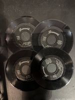 Four Brunswick 45 RPM records laid out label side up