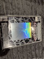 Front view of bagged The Amazing Spider-Man 30th Anniversary comic showing holographic foil cover and backing board
