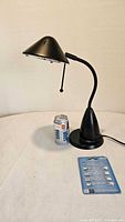 Lamp, beverage can for scale, blister pack of bulbs