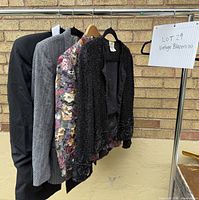 Four garments on rack highlighting two vintage blazers (grey herringbone and floral print)
