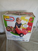 Front view of sealed Cozy Coupe Trailer box showing product image and branding