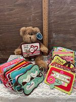 Teddy bear centered with stack of felt tags and ruler for scale