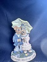 Front view of resin teddy bear couple figurine under umbrella