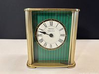 Front view showing dial, green striped background and Tiffany & Co branding