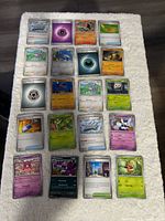 Full layout of 20 Pokémon cards on white surface