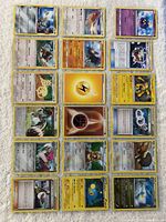 Overall view of all 18 Pokémon cards laid out in three columns