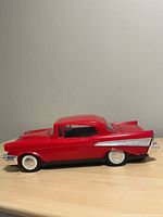Left side profile of red 1957 Chevrolet Bel Air VHS rewinder