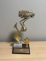 Full view of trophy showing van figurine, column, base