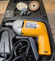 Drill, cord, bits, case interior compartments