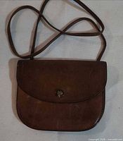 Front view showing flap, snap closure and strap