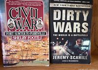 Both paperback books standing upright showing full front covers