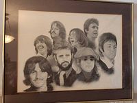 Full view of framed Beatles portrait print showing entire artwork, frame and cracked glass
