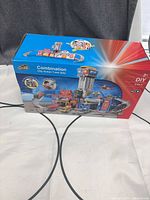 Front of box showing DIY 2-in-1 city action track set and included vehicles