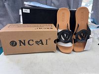 Sandals beside ONCAI box