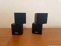 Front view of four stacked Bose cube speakers