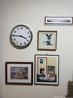 overview of wall clock and framed prints