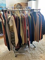 Full rack showing large quantity of assorted men’s sweaters.