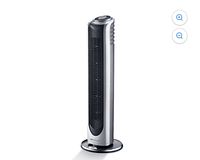 Full front view of silver/black Bionaire tower fan on round base