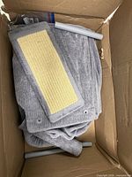 Grey carpeted panels, support tubes and sisal post inside box