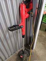 Full view of Craftsman corded string trimmer standing upright