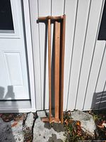 Full view of wooden shelf leaning against wall
