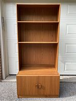 Front view showing entire two-piece teak bookcase and cabinet
