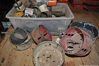 bin filled with assorted hole saws plus large cutters in front