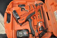 Open hard case showing Paslode CF325Li framing nailer, battery, charger