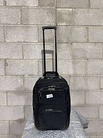 Full view of black Heys softside carry-on suitcase with handle extended
