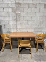Dining table with three of the four chairs around it